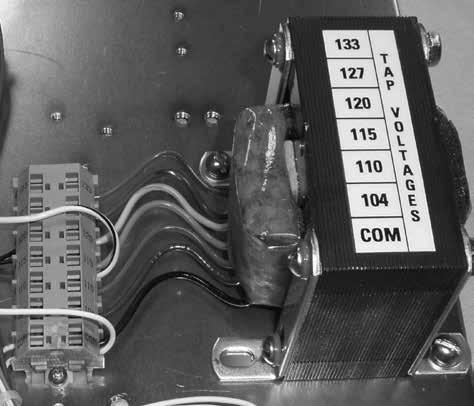 Push the interface cable terminal connector into an open accessory jack on the hinge side of the control panel. Use the lower jack (Com2); if Com2 is in use, use the upper jack (Com3). See Figure 6.