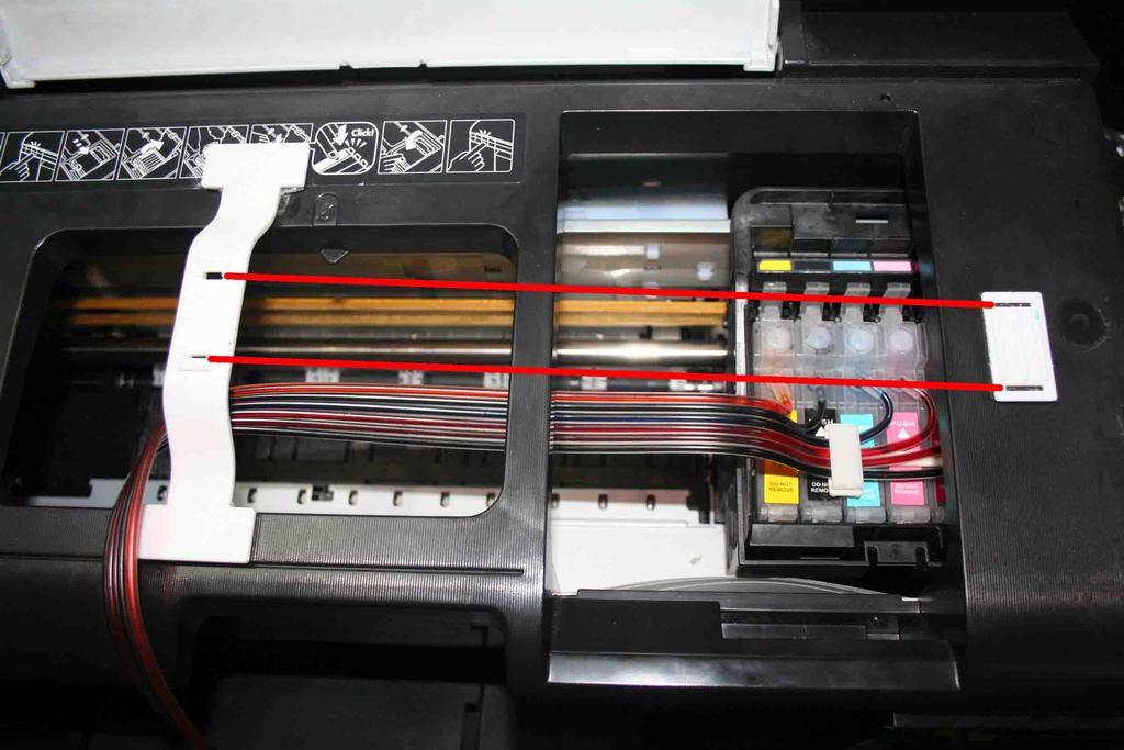 Move the cartridge thru the printer cover As above shown Lock the cartridges