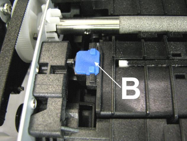 Insert the right-hand Spacer (smaller) into the hole in the Service Station Platen [A]. 2. Insert the left-hand Spacer (larger) in the hole on the left end of the Service Station Platen [B]. 3.