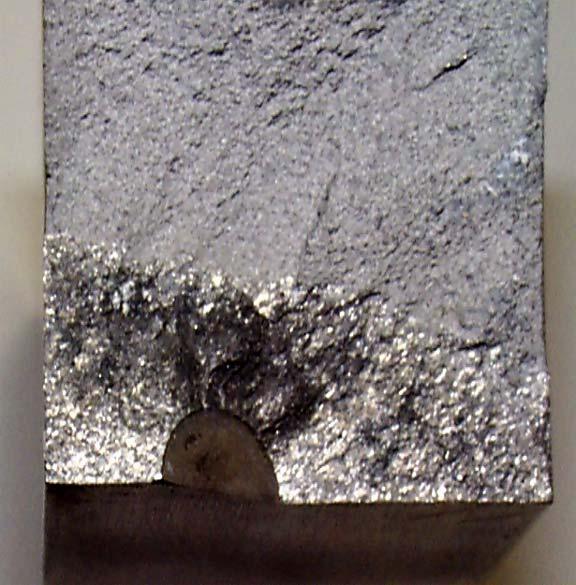 Figure 28. Final observed crack shape. The shiny fracture surface is the fatigue crack; duller surface is fast fracture, Example 14.