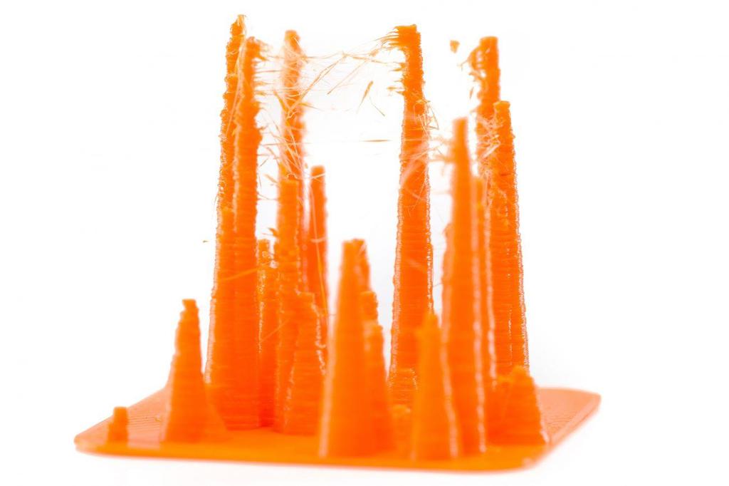 way stringing (thin threads of plastic in between the printed objects) is prevented. The below image shows an example of what happens when retraction is disabled.
