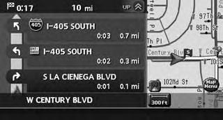 An enlarged intersection view is automatically displayed when the vehicle approaches the guide point.. Turn list can be scrolled using the center dial or the main directional buttons.