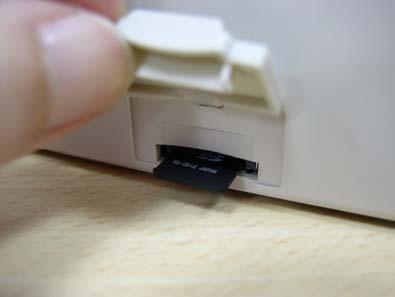 Insert the MicroSD card into the socket. 3. Close the memory card cover.