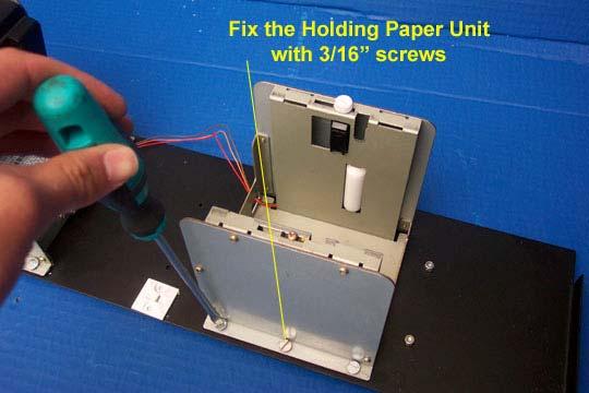 8.1.4 Paper Holding Unit To install the paper-holding unit you need six (6) M5 x 15 screws: 1. Place the paper holding unit on the printer tray. 2.