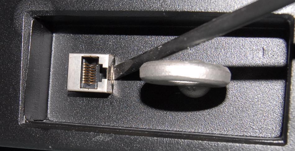 b) Use a slotted screwdriver to push in on the black clip to release it from the EC2000 s case (see Figure 3-7).