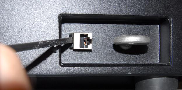 3 - Ethernet Jack Replacement Procedure Figure 3-7 - Use the Slotted Screwdriver to Release the Black Clip (REAR VIEW) 11) Ease
