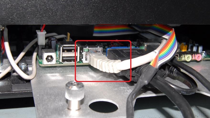 connection point for the network cable. It is located next to the security anchor ring on the rear of the device.