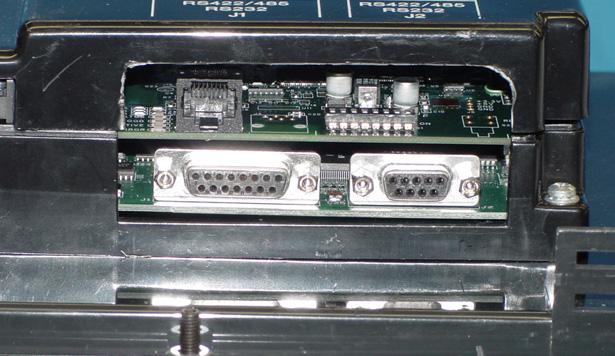 Save the user program to disk. b. Disconnect panel power source. c. Open back cover (shown open in figure to the right) to install the card. d. The connector on the bottom right side of the card installs into the backplane connector.