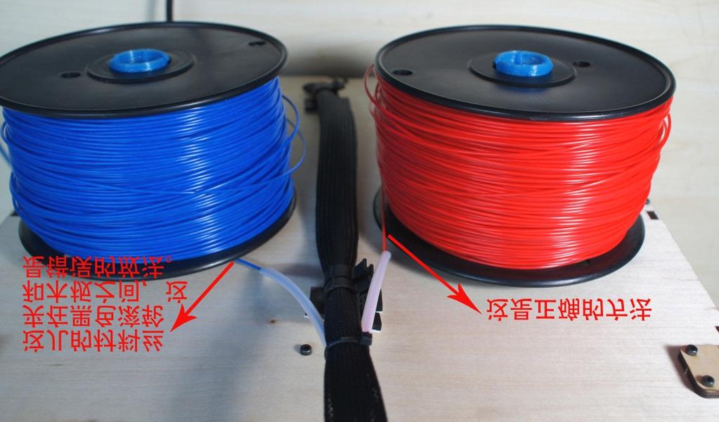 The blue filament is stuck between the black wheel and board, which