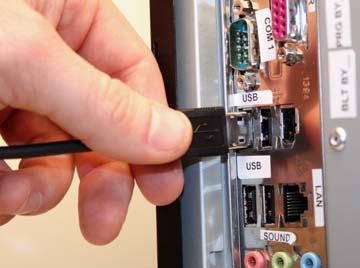 To detach the cable from the reader, you must pinch the plastic on the 8-pin DIN and pull back to disengage the connector. FIGURE 1 15. Handle with Cable Attached USB Cable Connection 1.