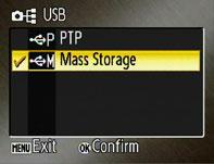 Turn the camera on. Press the MENU button and select Mass storage for the Interface > USB option in the setup menu.
