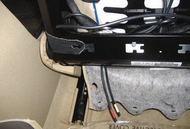 6. Route the headrest cables to the bottom outboard side of the seat.