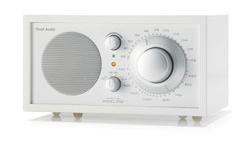 MODEL ONE - Frost White Collection The Frost White Collection Model One AM/FM table radio features a pure white handlacquered cabinet, silver knobs, and a vibrantly coloured faceplate.
