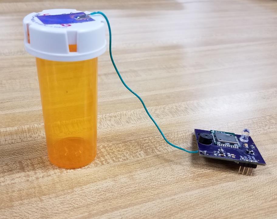 Figure 4.13: Finished prototype with PCB hardware and medication bottle. 4.1.2 Notes on Hardware Design After having ordered the prototype PCB shown in Figures 4.14 and 4.