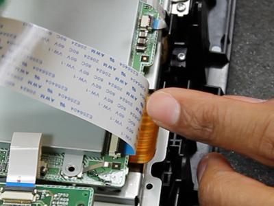 Disconnect the large brown ribbon cable from the factory board and insert the ribbon cable from the nav