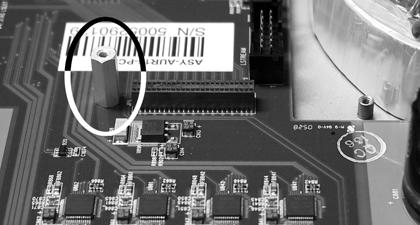 Remove the screw from the Aurora circuit board that is adjacent to the JP1 connector and the white serial