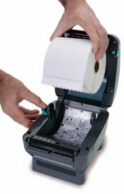 Open the printer by applying pressure to the release levers located on the sides of the printer, toward the front. Remove any test bar code labels if present. 4.