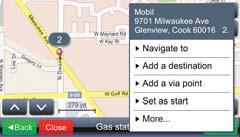 The navigation map displays the POI location and a list of options. Choose an option from the menu if you want to add the place to your route (e.g. touch Add a via point.
