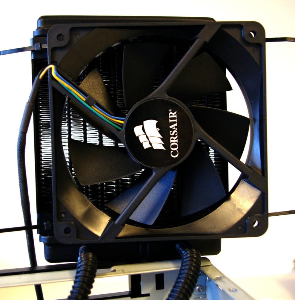 To allow the drive tray to fit the fan needs to sit lower on the radiator, necessitating the use of cables ties instead of screws attach it using cable ties.