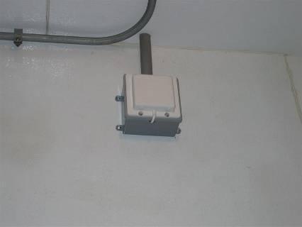FIGURE 1: FSE junction box with a 12 long x ¾ NSF Plain End PVC conduit (gray) installed from the outside (attic) of the freezer/chill storage to the inside (ceiling) Only 2 of the PVC conduit will