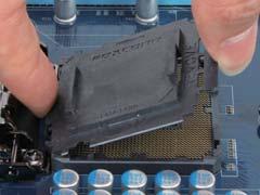 Step 4: Once the CPU is properly inserted, use one hand to hold the socket lever and use the other to