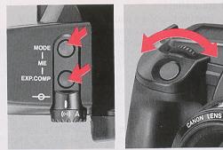 1) Press both the shooting mode selector and the exposure compensation button simultaneously.