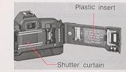 CAUTION * Before loading the first roll of film, remove the plastic insert. * NEVER touch the shutter curtain. Its high-precision design makes it sensitive to pressure.