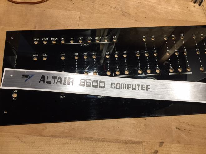 Apply the metallic Altair 8800 sticker. Attach the front panel to the topside of the circuit board.