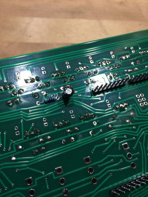 On the underside of the board, solder the 47µF capacitor (mind the polarity negative away from the