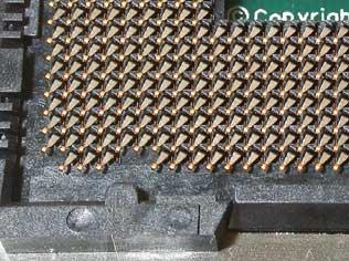 The Foxconn contacts depress in a diagonal direction towards pin 1 of the CPU, as shown in Figure 1.
