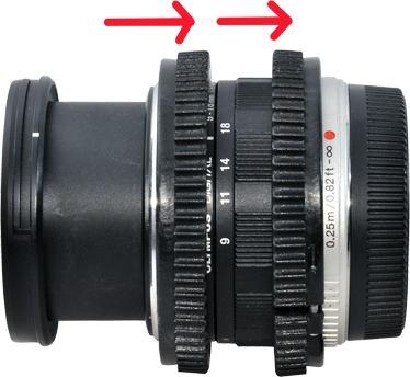 Use Zoom Control Button - 23 and Focus Control Button - 21 on the housing to adjust zoom and focus for this lens Olympus M.