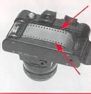 Fire shutter. Advance film by short strokes of transport lever until both top and bottom sprockets are engaged.