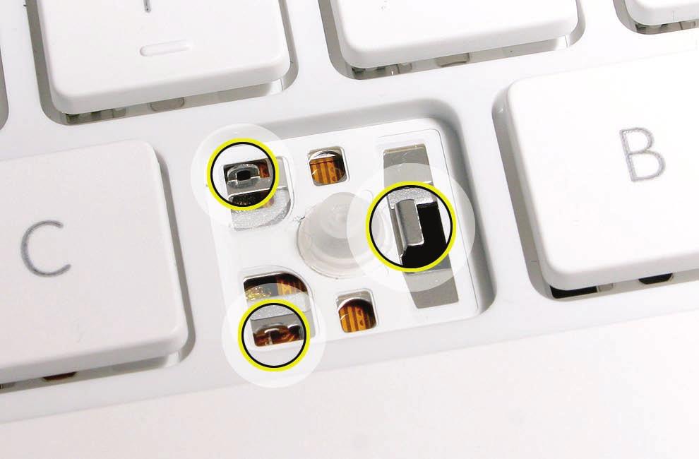 4. Check the underside of the keycap for two clips on one side and two hooks on the other side. If any of the hooks or clips are bent, broken, or missing, replace the keycap.