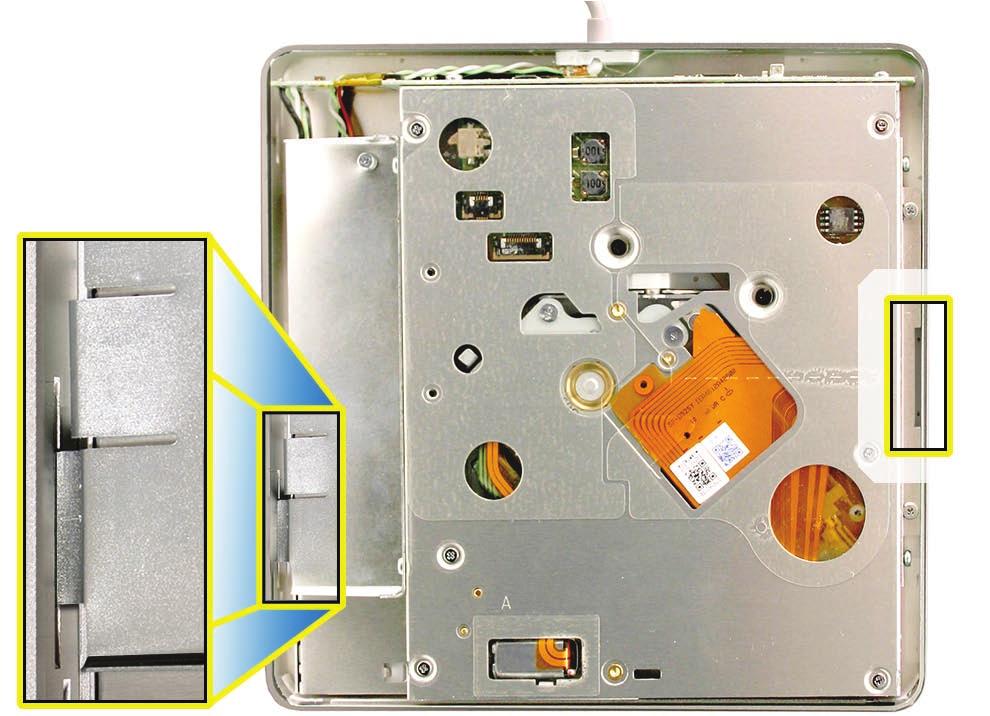 5. Note the tab on the lower left of the drive casing which fits into a recessed slit in the outer enclosure (shown in left blowout area below.