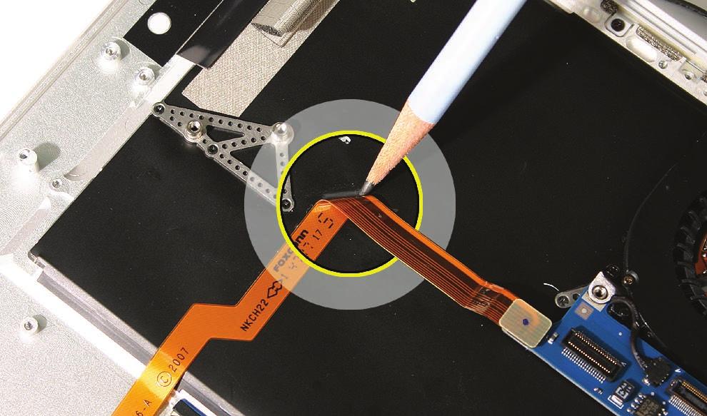 3. As in the above step, use the pencil to very lightly trace the upper bend in the cable onto the black mylar, precisely from fold to fold, being careful of the keyboard assembly beneath.