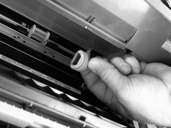 3. Gently pull the roller up and out of the all-in-one. Figure 5-92 Removing the printer pickup roller (3 of 5) 4.