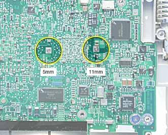 3. Turn over the computer frame and remove the two Phillips screws that secure the logic board to the heat spreader plate: 5-mm long screw (near center of board) 11-mm long screw (near edge