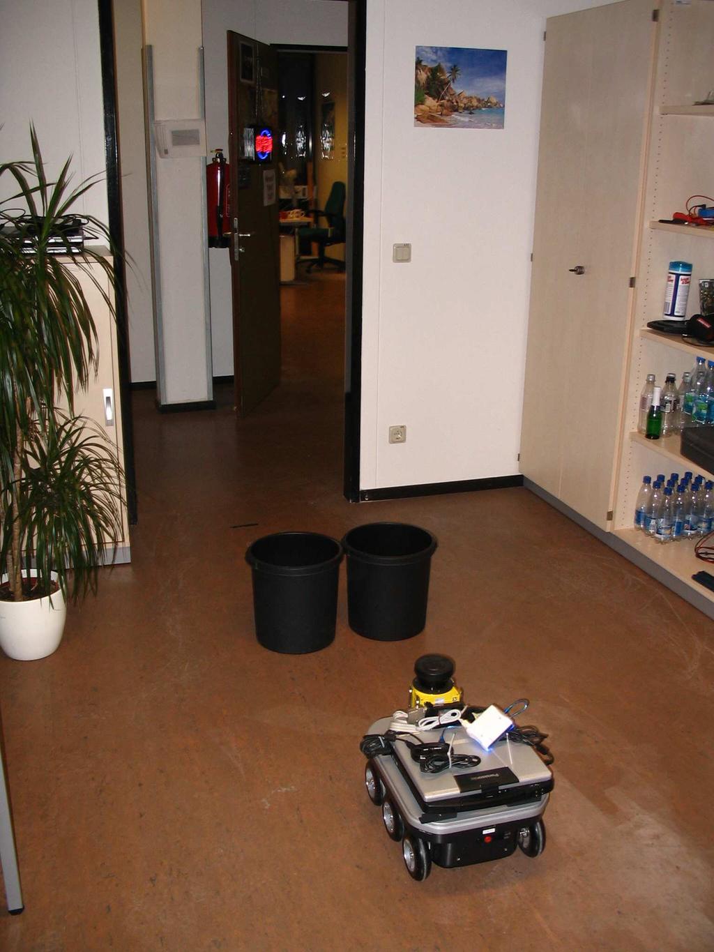 Fig. 8. Left: Experimental setup Middle: The VRS (blue) is aware of the obstacles due to the PMD camera (red points). Right: The robot navigates around the wastebins. VI.