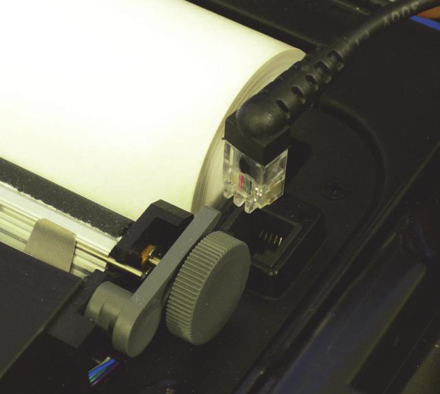 Printing a Self-Test 1. Open the printer's cover. 2. Press and hold the red self-test button for 4-5 seconds, until the printer starts to print (Figure 13). Figure 13 3.