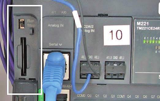 11. Move the switch above the SD card slot to the STOP position. Wait 5 seconds, then move the switch back to the RUN position. The RUN light on the PLC will illuminate.