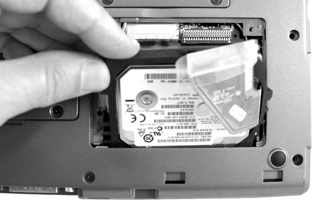 The hard drive assembly fits tightly in the hard drive bay. Grip the hard drive at the top edge of the rubber boot that surrounds the hard drive and slowly work it out of the bay.