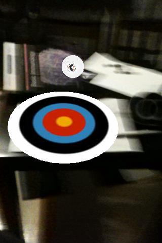 The archery target is placed on top of the marker, and the ball is floating about in the air.