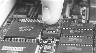 Use a chip puller to remove the Ethernet address ROM from its socket between the dc and VRAM chips.