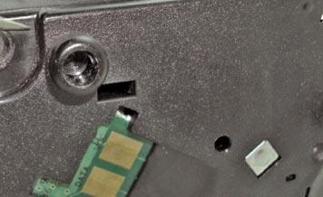 Place the cartridge in horizontal position with the side cover holding the chips facing you.