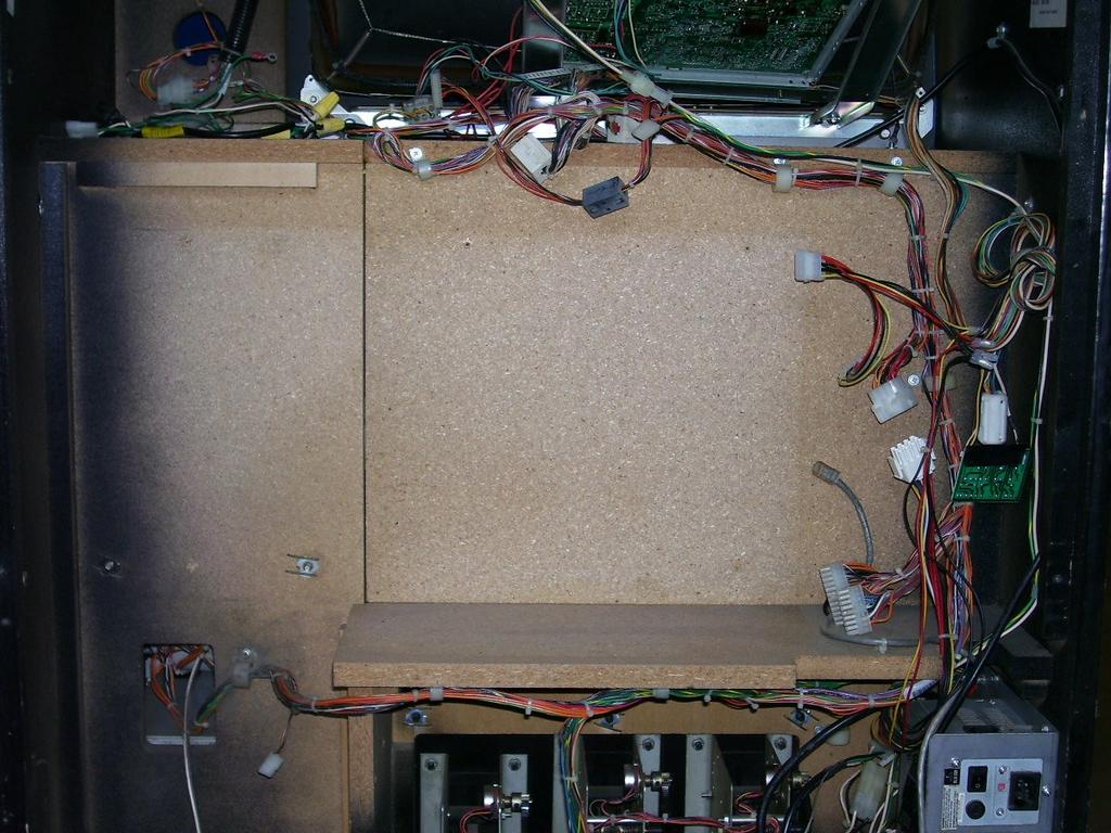 ONCE ALL THE CABINET CABLES ARE DISCONNECTED FROM THE MAIN ELECTRONICS ASSEMBLY, REMOVE THE SCREWS HOLDING THE MAIN ASSEMBLY IN
