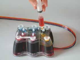 b) Using the syringe with the large needle attached, remove any excess from the air chamber. Please discard this excess ink.