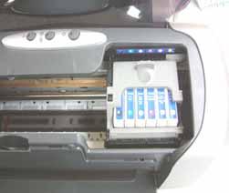 The cartridge holder will move into the middle of the printer.