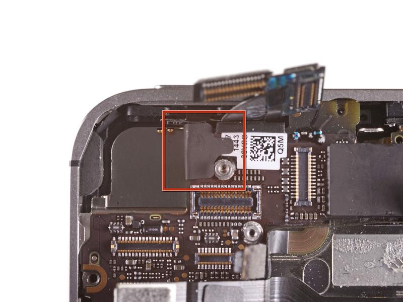 Step 18 If present, peel the piece of black tape covering the hidden screw near the power button. Remove the 2.6 mm Phillips screw securing the logic board near the power button.