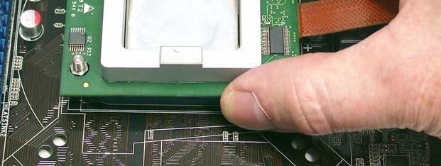 Slowly lower the probe onto the CPU and socket,