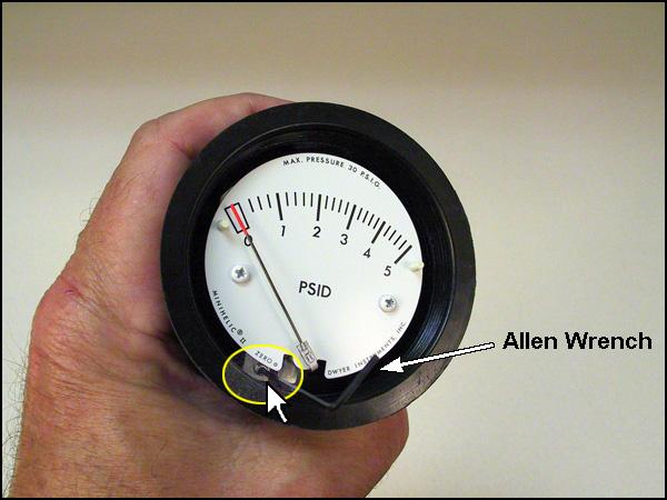 If the gauge needs to be calibrated, insert the provided Allen wrench into the adjusting screw and make adjustments as necessary.